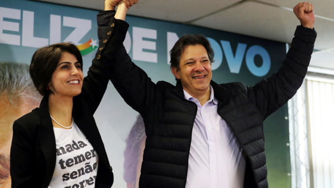 Fernando Haddad, former Sao Paulo mayor and member of Workers' Party (PT), and Manuela D'avila of the Communist Party of Brazil (PCdoB) pose before a media conference in Sao Paulo