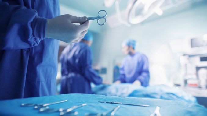 Doctors performing surgery in hospital operating room